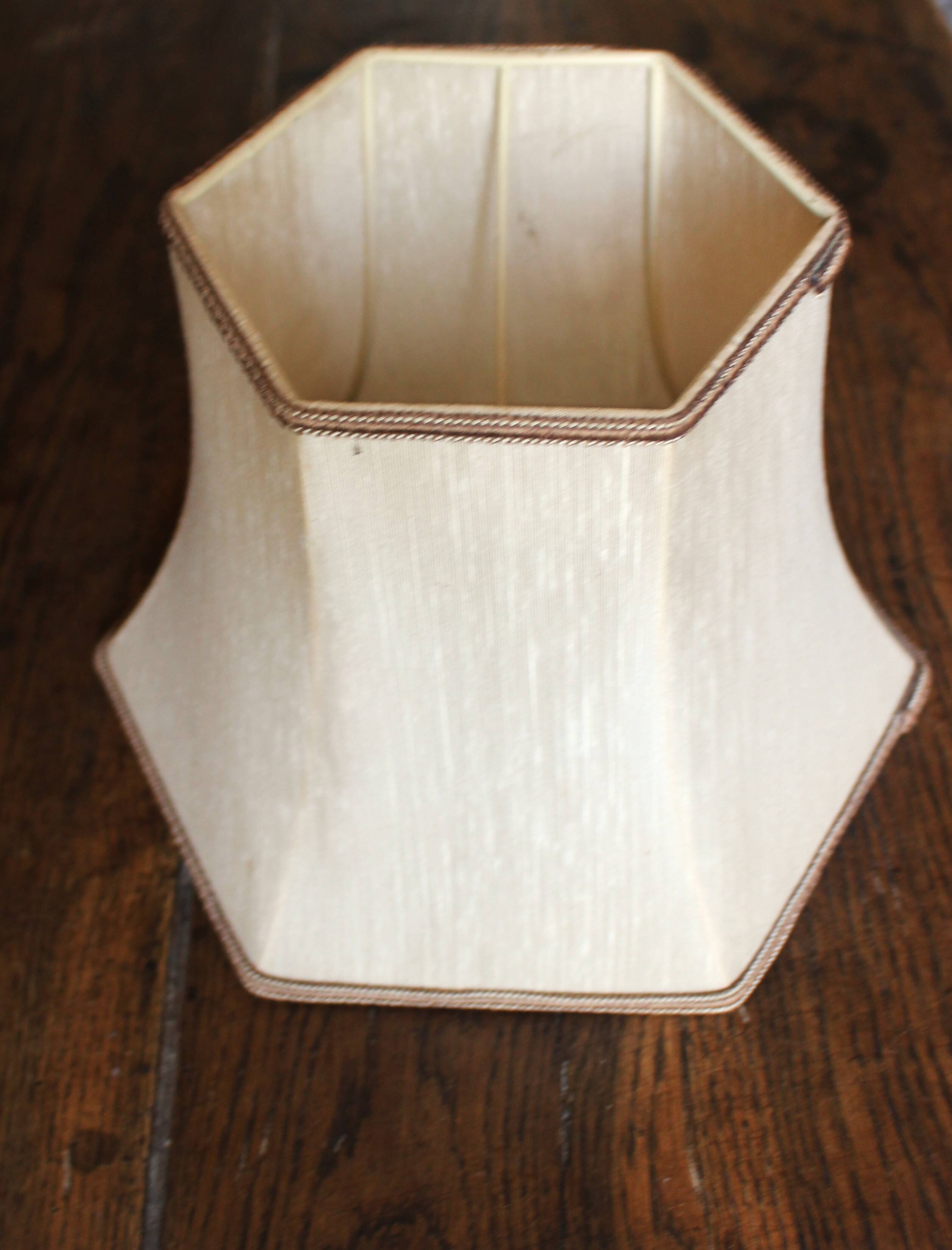 Table lamp with a patinated base and vintage woven shade.
