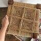 Low stool with carved wood and braided cord.