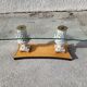 Italian coffee table with glass top, wooden base, and porcelain legs