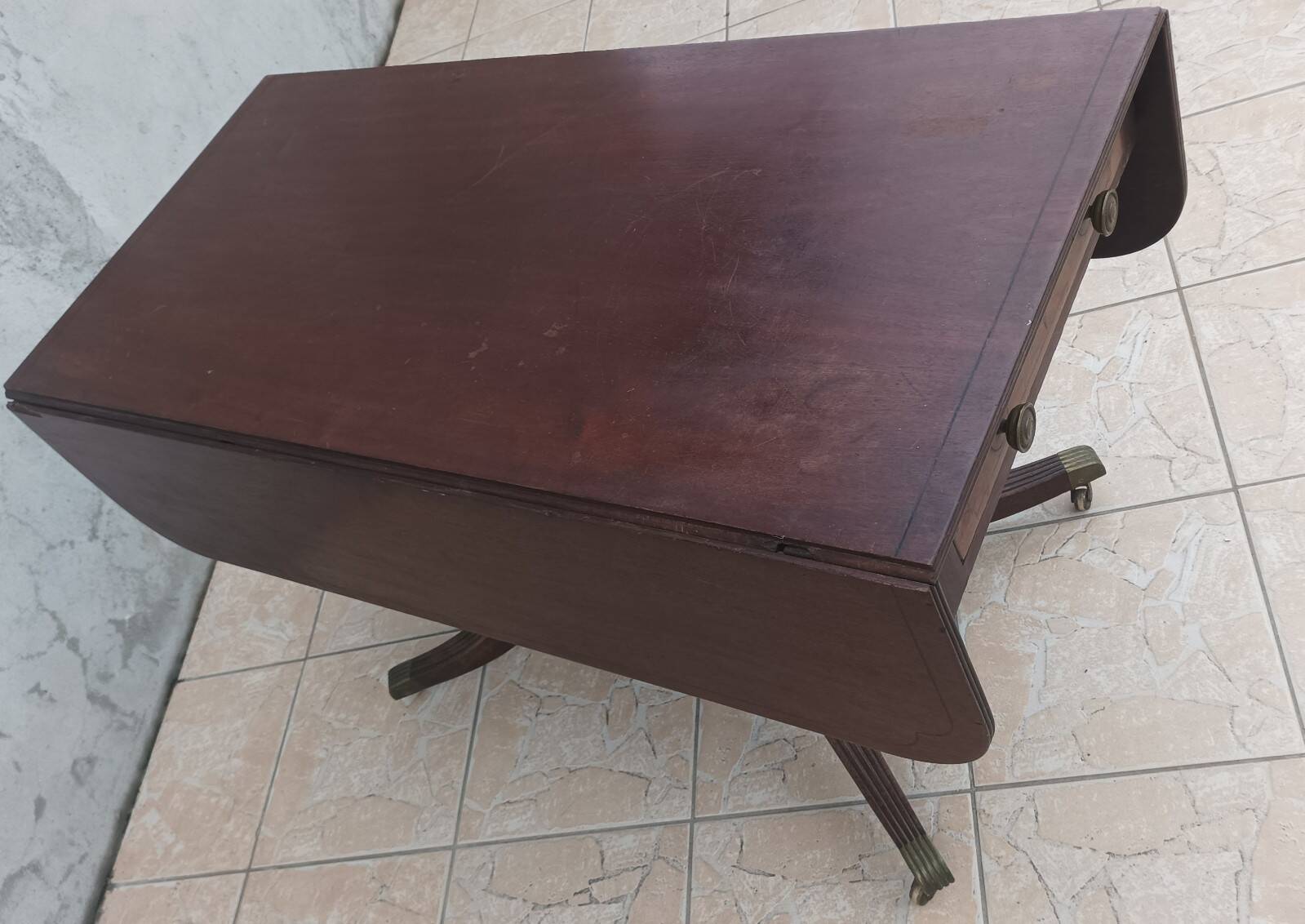 19th-century English style mahogany drop-leaf table.