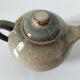 Vintage ceramic teapot with a flame design.