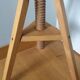 Tripod stool with a screw.