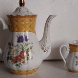 Golden porcelain teapot and coffee pot set with floral design and matching milk jug.