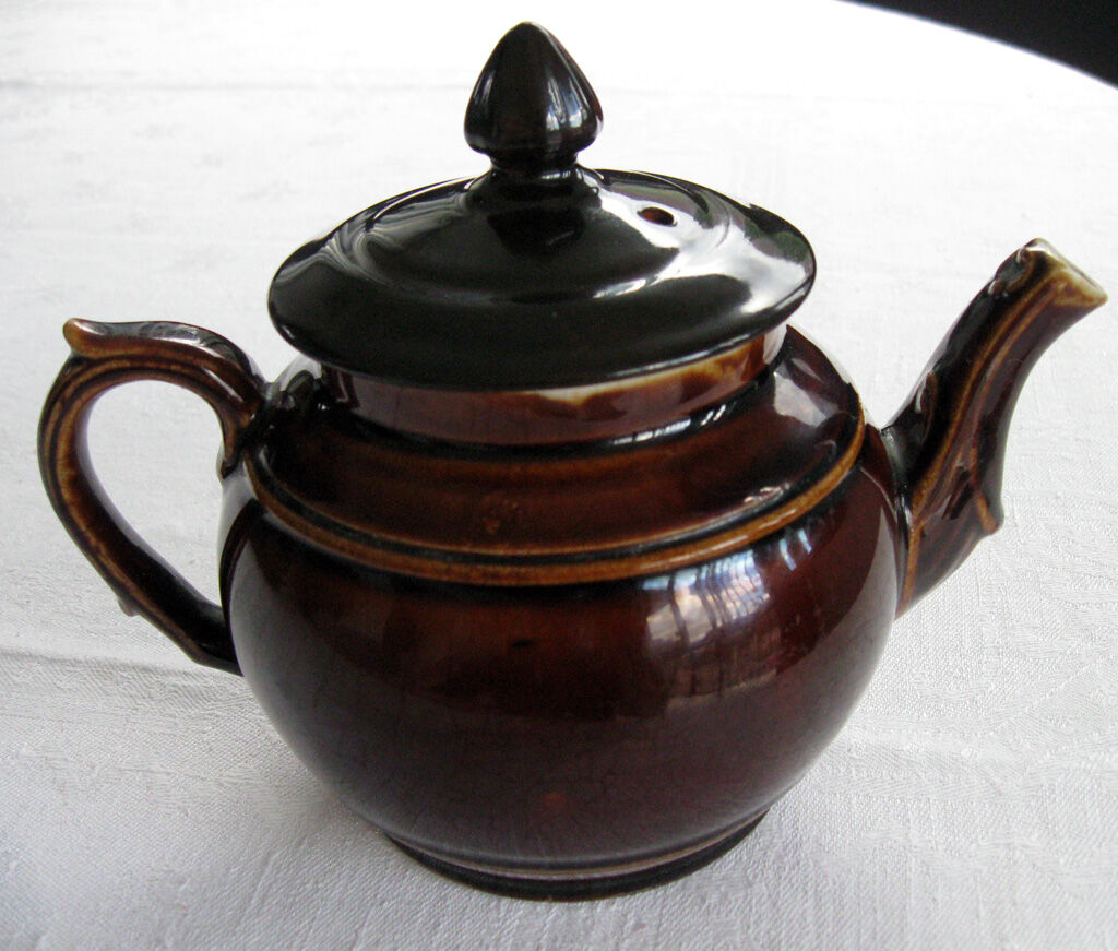 Old brown glazed ceramic coffee pot