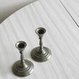 Pair of small metal candle holders, classic design.