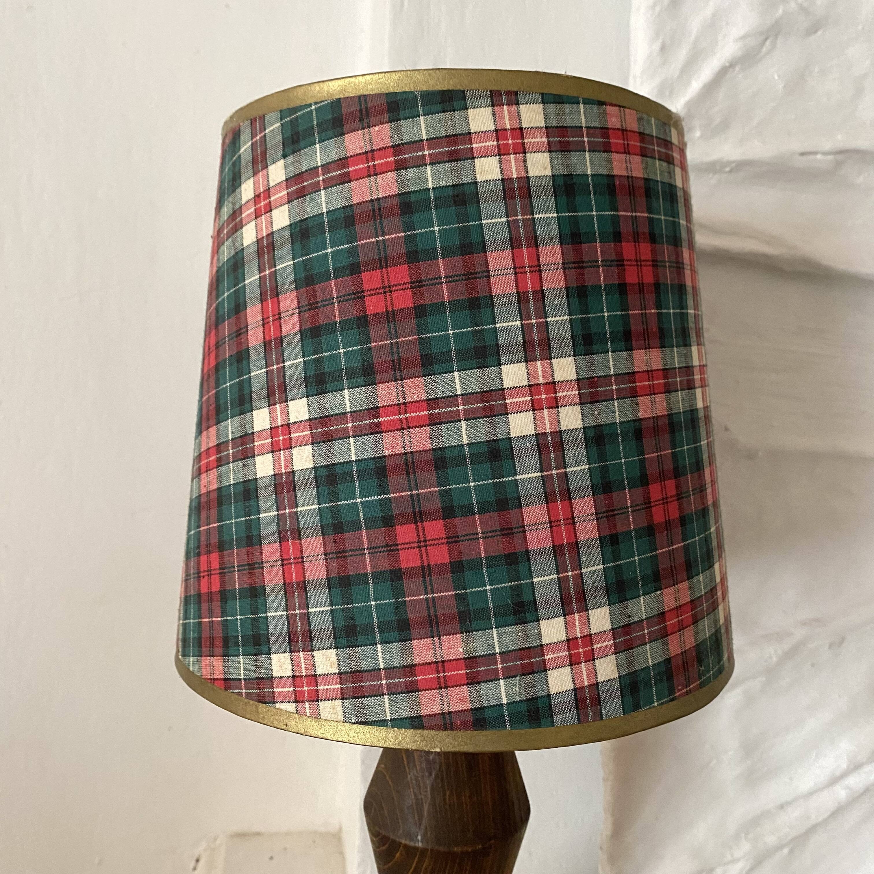 Turned wooden lamp, tartan lampshade.