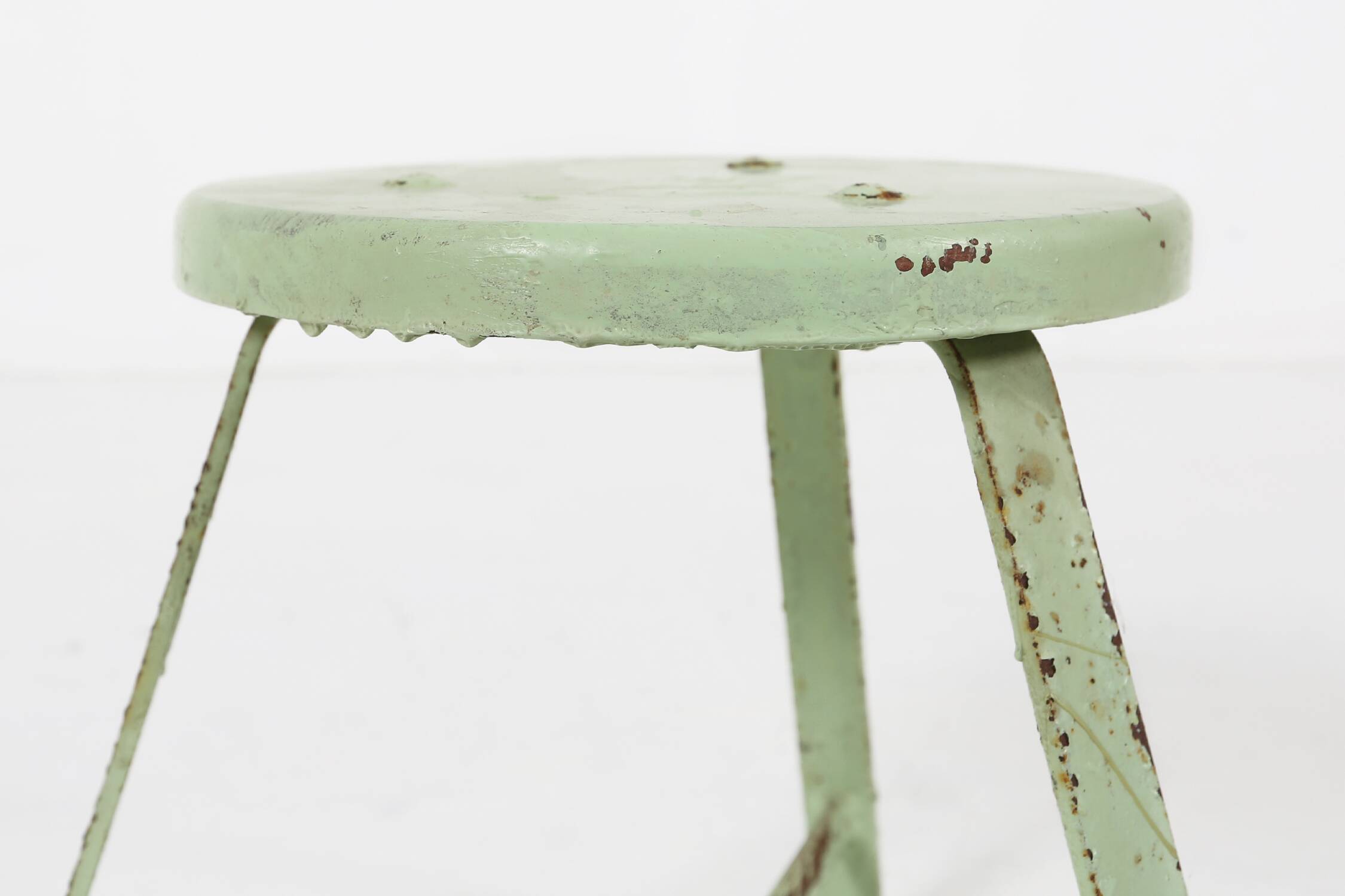 Industrial green painted stool with steel base and wooden top, France 1930s