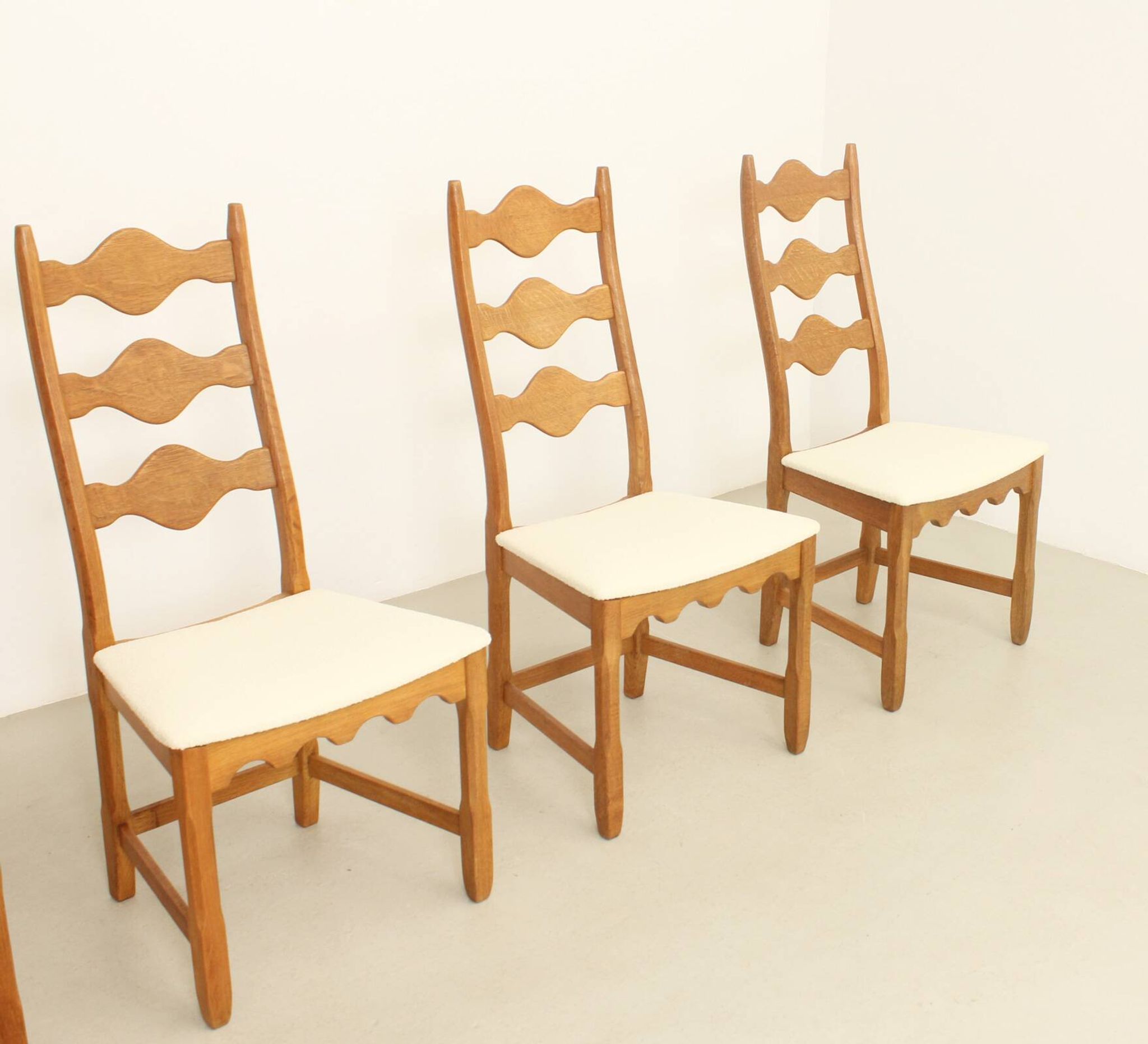 Four oak dining chairs by Henning Kjaernulf.