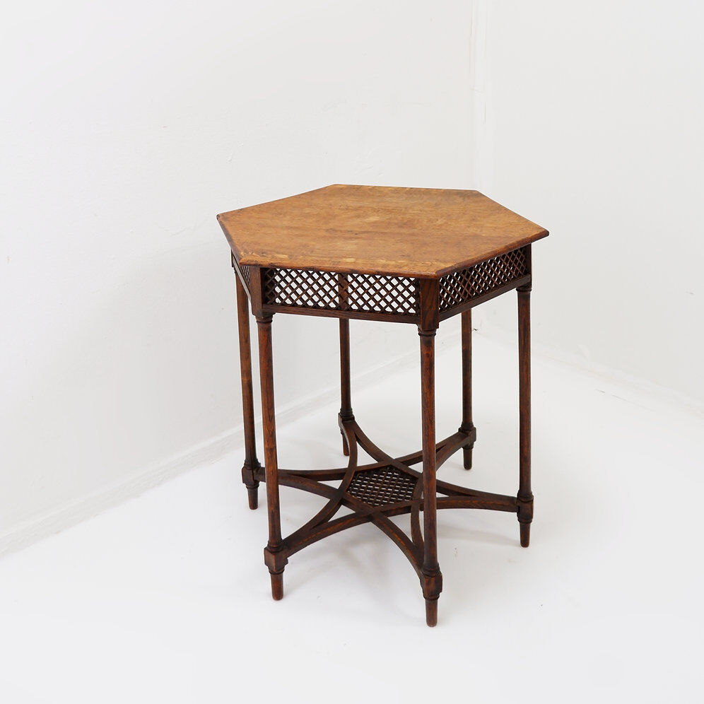 Hexagonal pedestal table or side table with a lattice structure and star pattern.