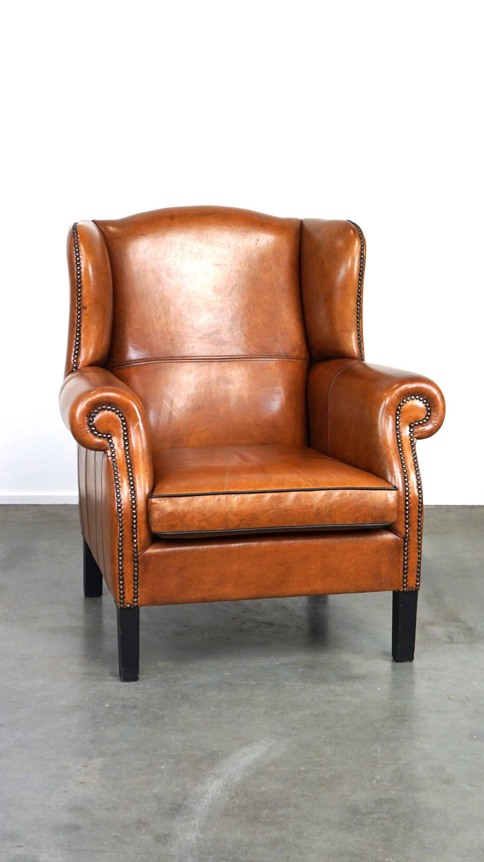 Très beau fauteuil à oreilles en cuir de mouton avec des détails époustouflants