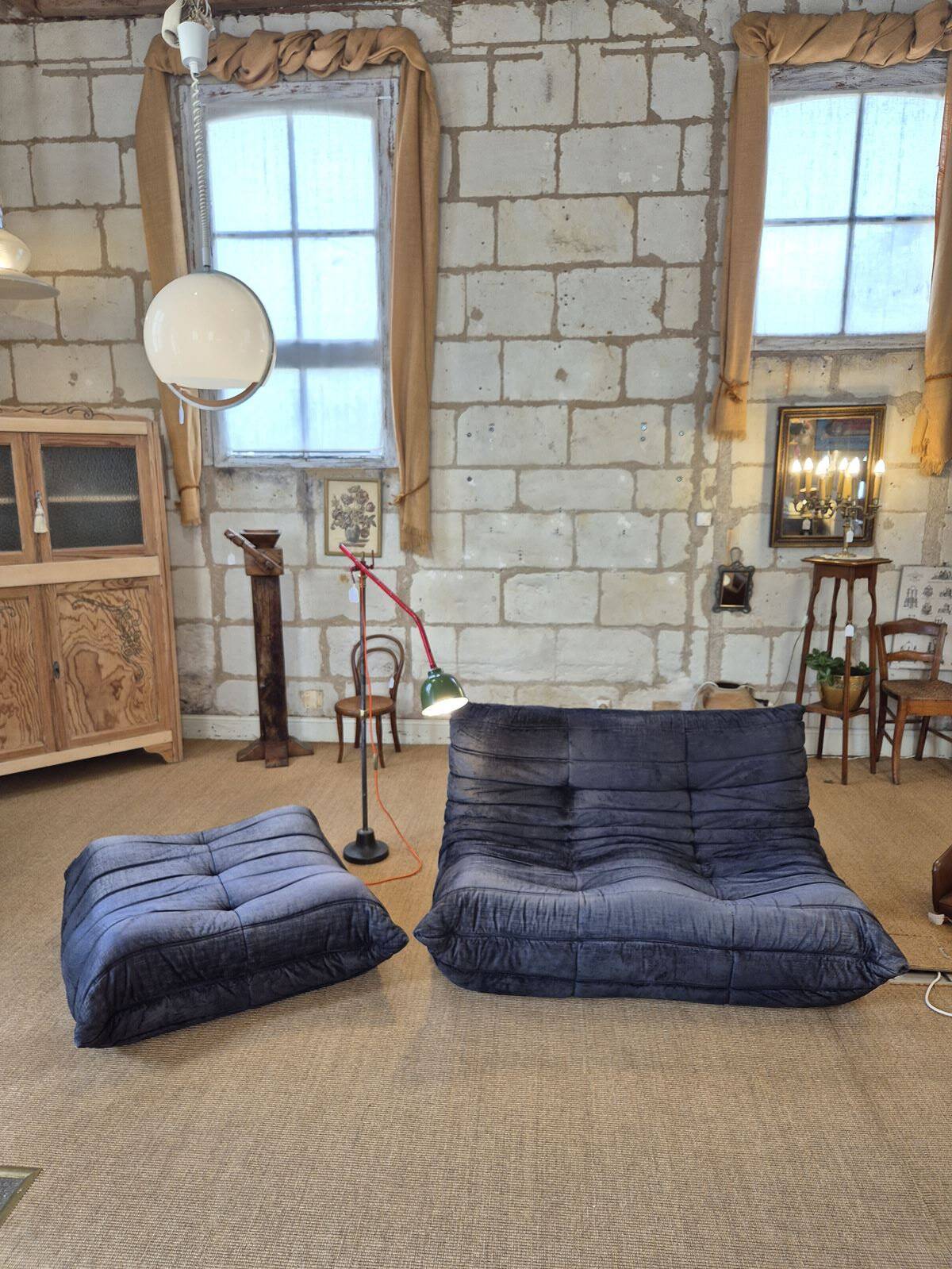 Togo sofa by Ligne Roset and its pouf from the 1970s.