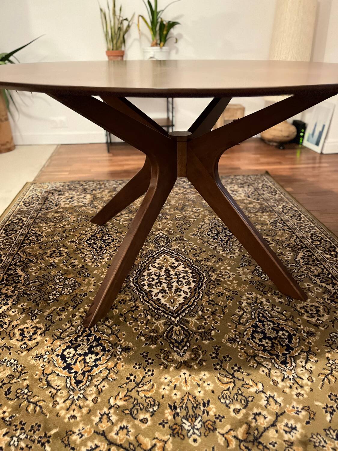 Round table made of solid wood with a walnut finish top.