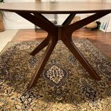 Round table made of solid wood with a walnut finish top.