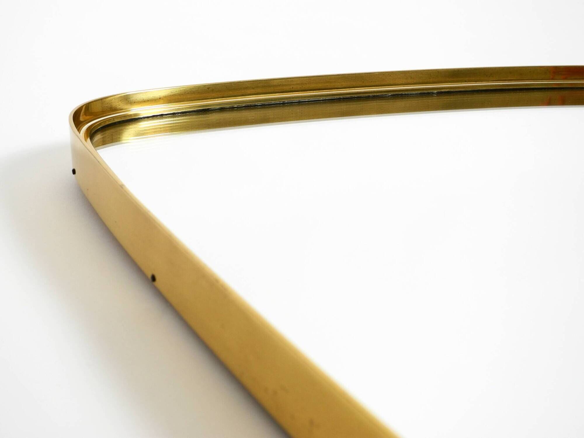 A pair of rare Mid Century "Münchener Zierspiegel" brass wall mirrors