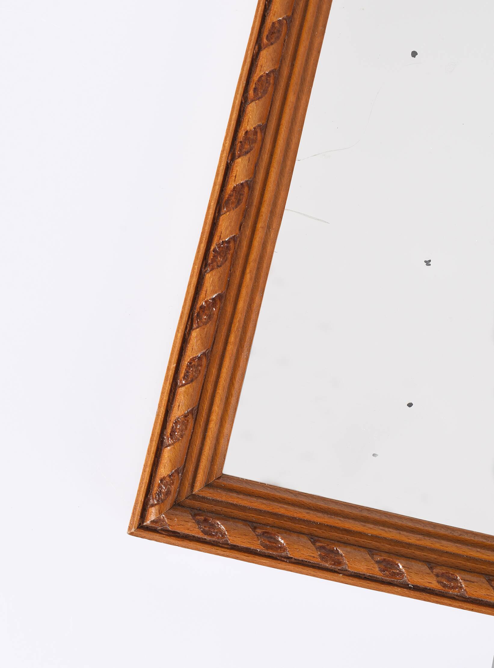 Small old wooden mirror with carved frame