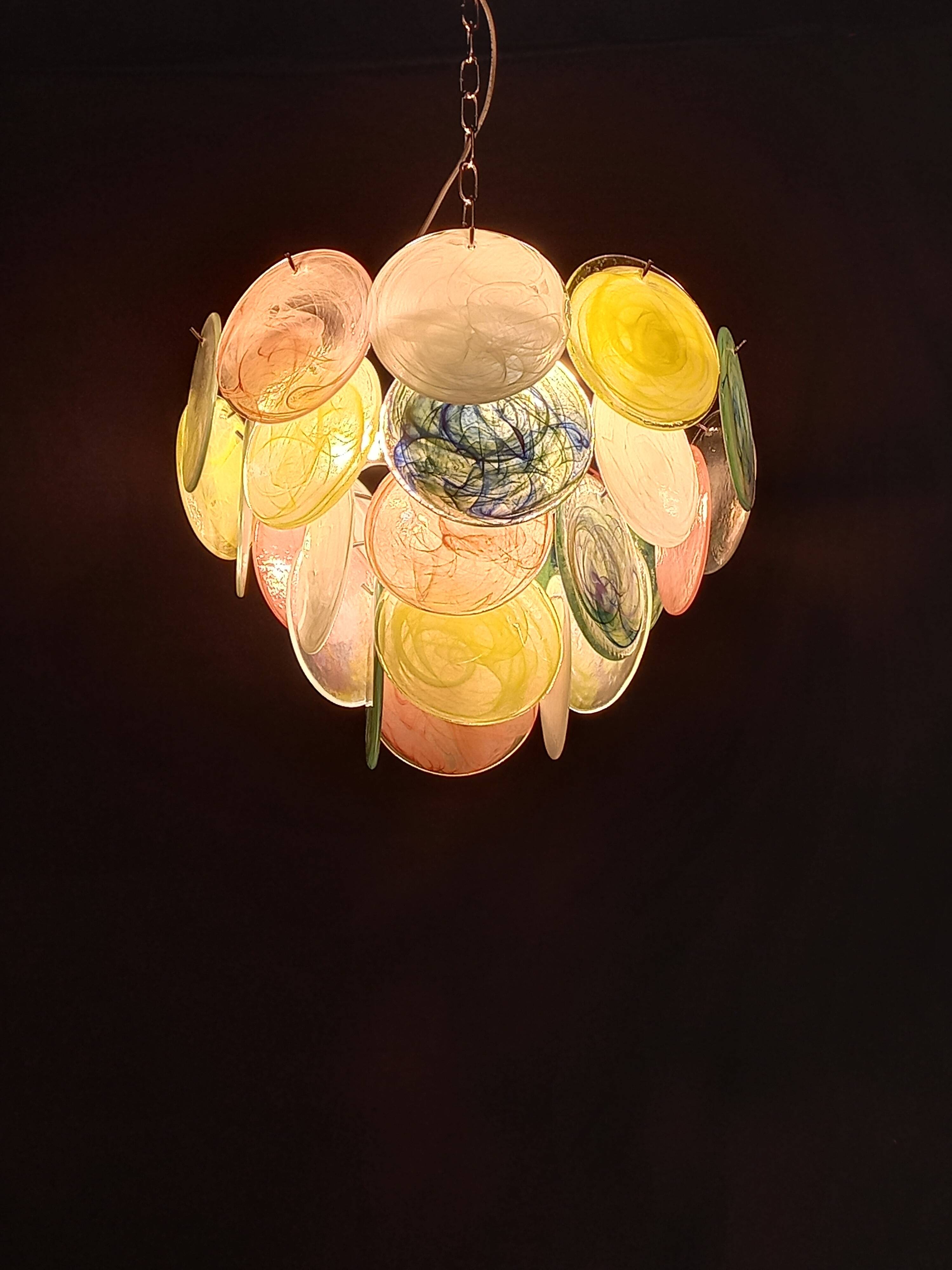 Handcrafted chandelier with Murano glass discs.
