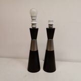 Two table lamps made of dark-stained wood with silver detail in the middle.