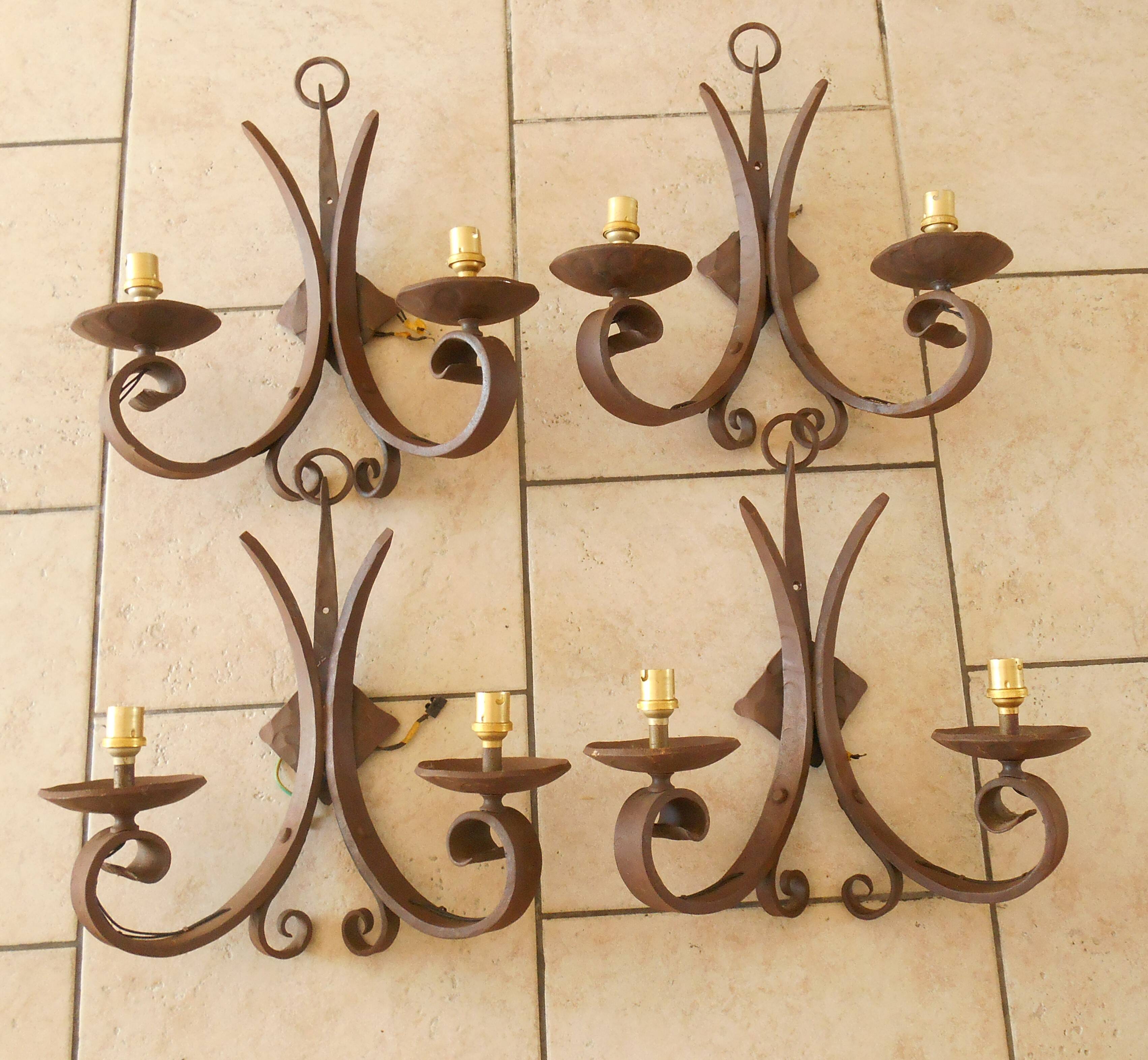 Four antique wrought iron wall lights
