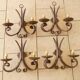 Four antique wrought iron wall lights