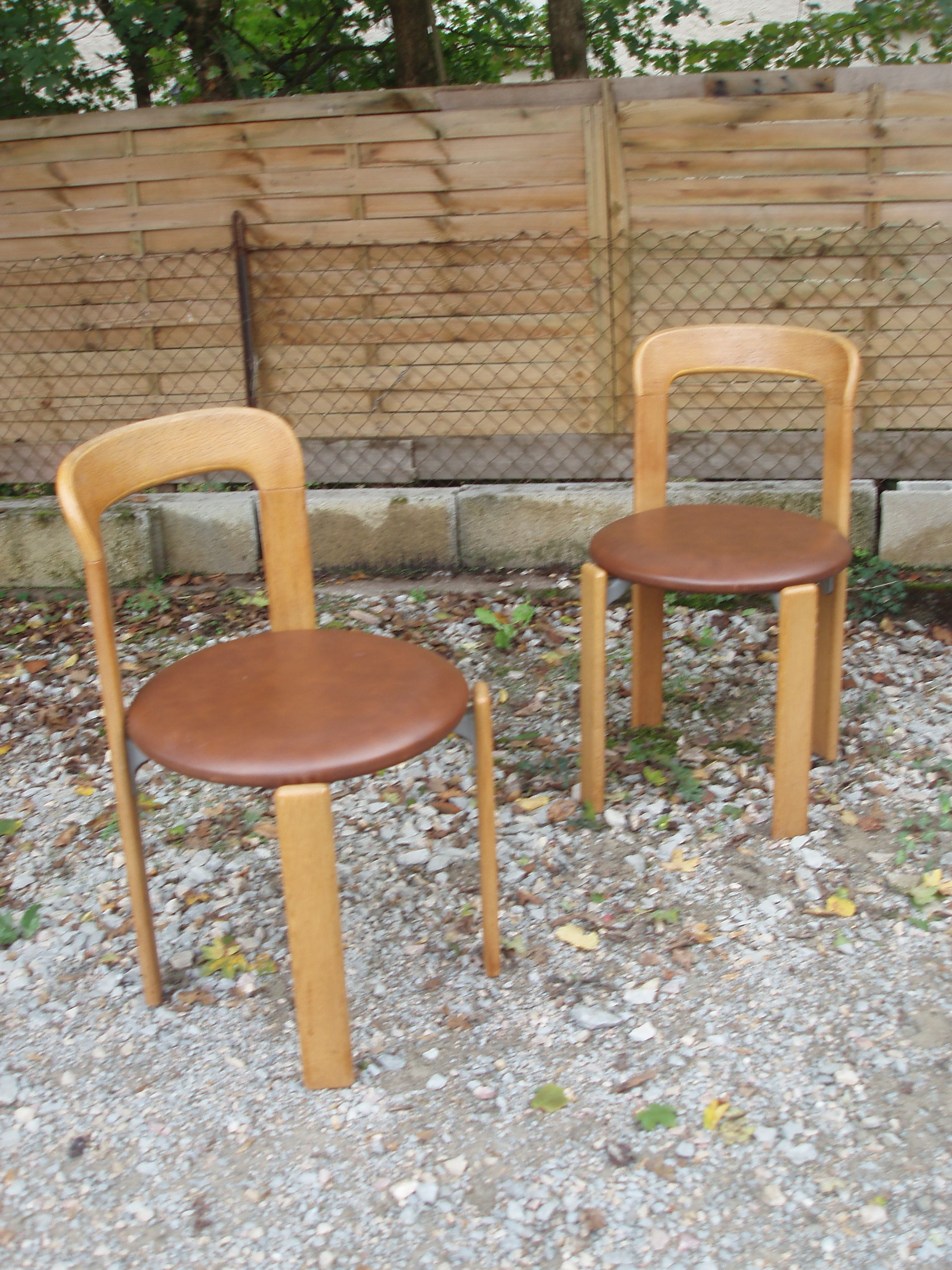 Pair of chairs by Swiss designer Bruno Rey in wood and brown skai