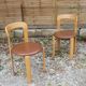Pair of chairs by Swiss designer Bruno Rey in wood and brown skai