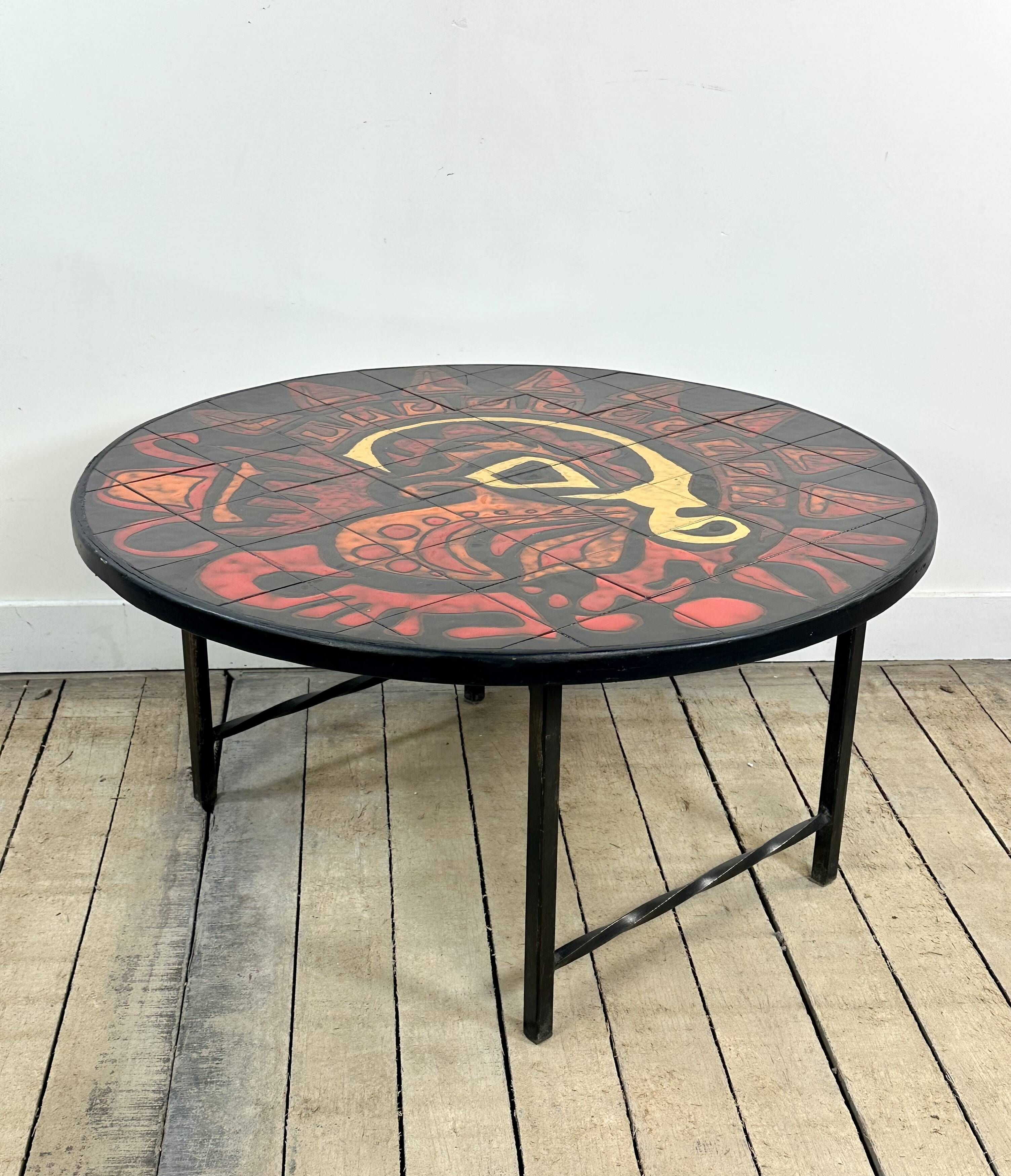 Vintage round coffee table in graphic red and yellow ceramic from the 1960s.