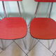 Table in red formica, 4 roc chairs, 2 extension cords, 2 drawers 60