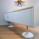 A vintage mid century space age sideboard with white sliding doors