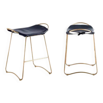 Pair of navy blue bar stools with gold brass finishes.