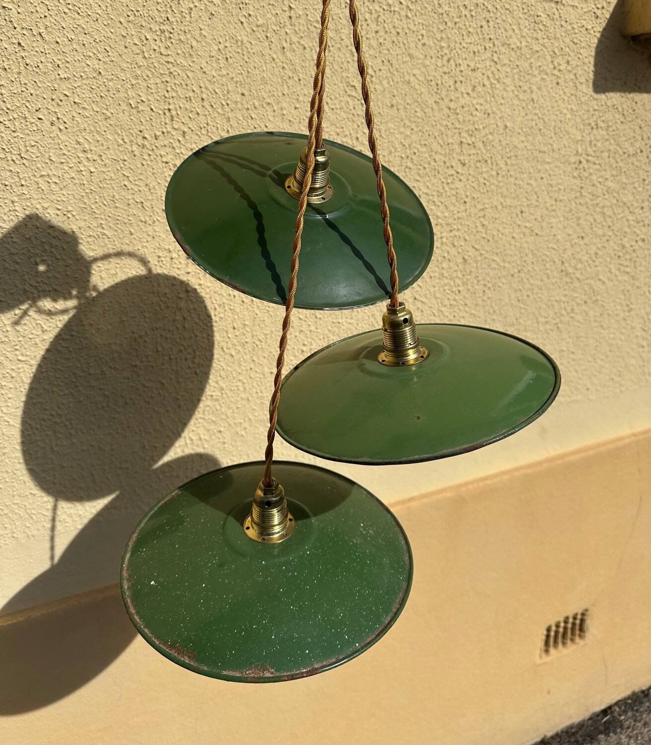 Trio of vintage green enamelled sheet metal lampshade pendants