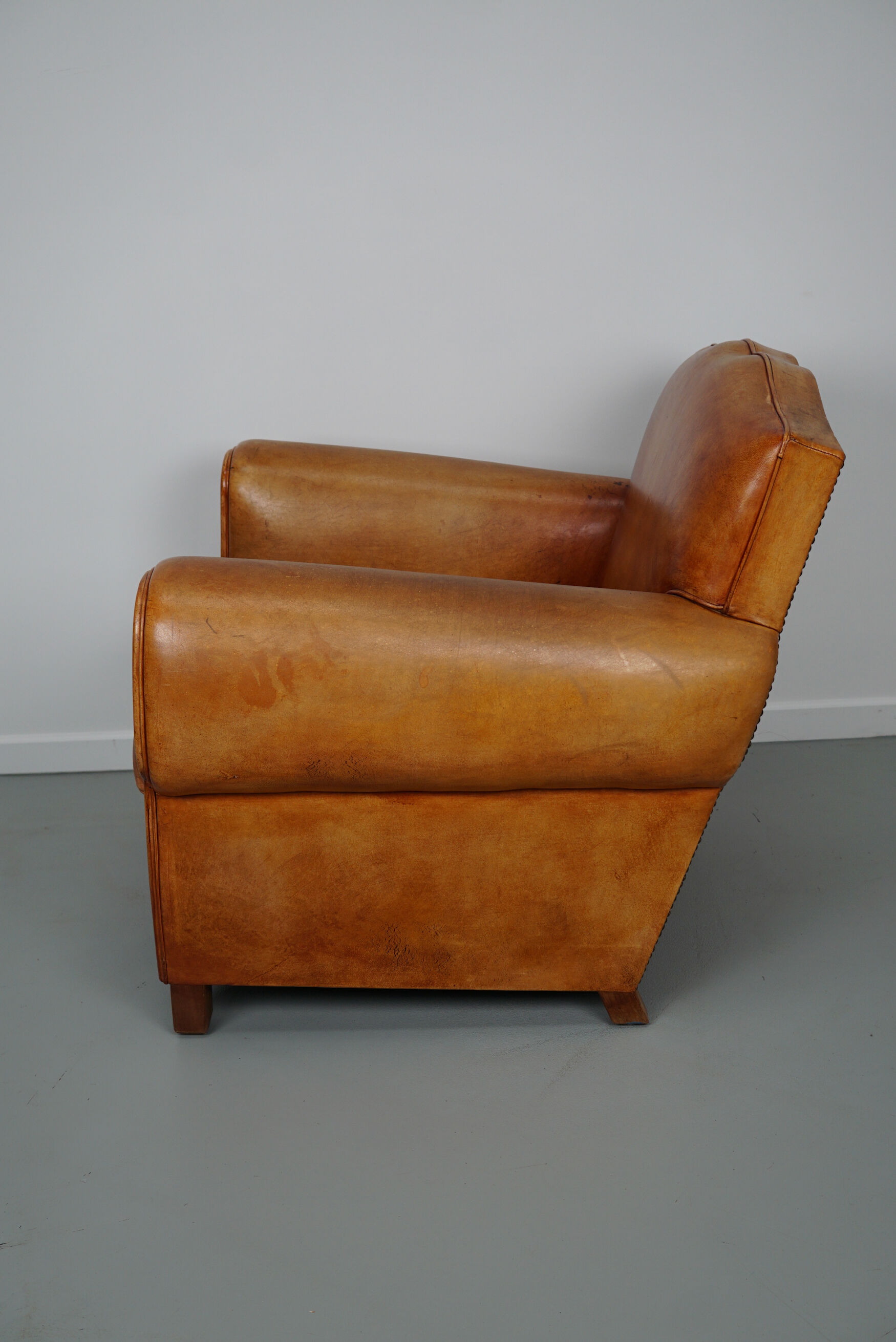 Vintage french moustache back cognac-colored leather club chair