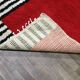 Tapis artisanal rouge et à rayures blanches et noires
