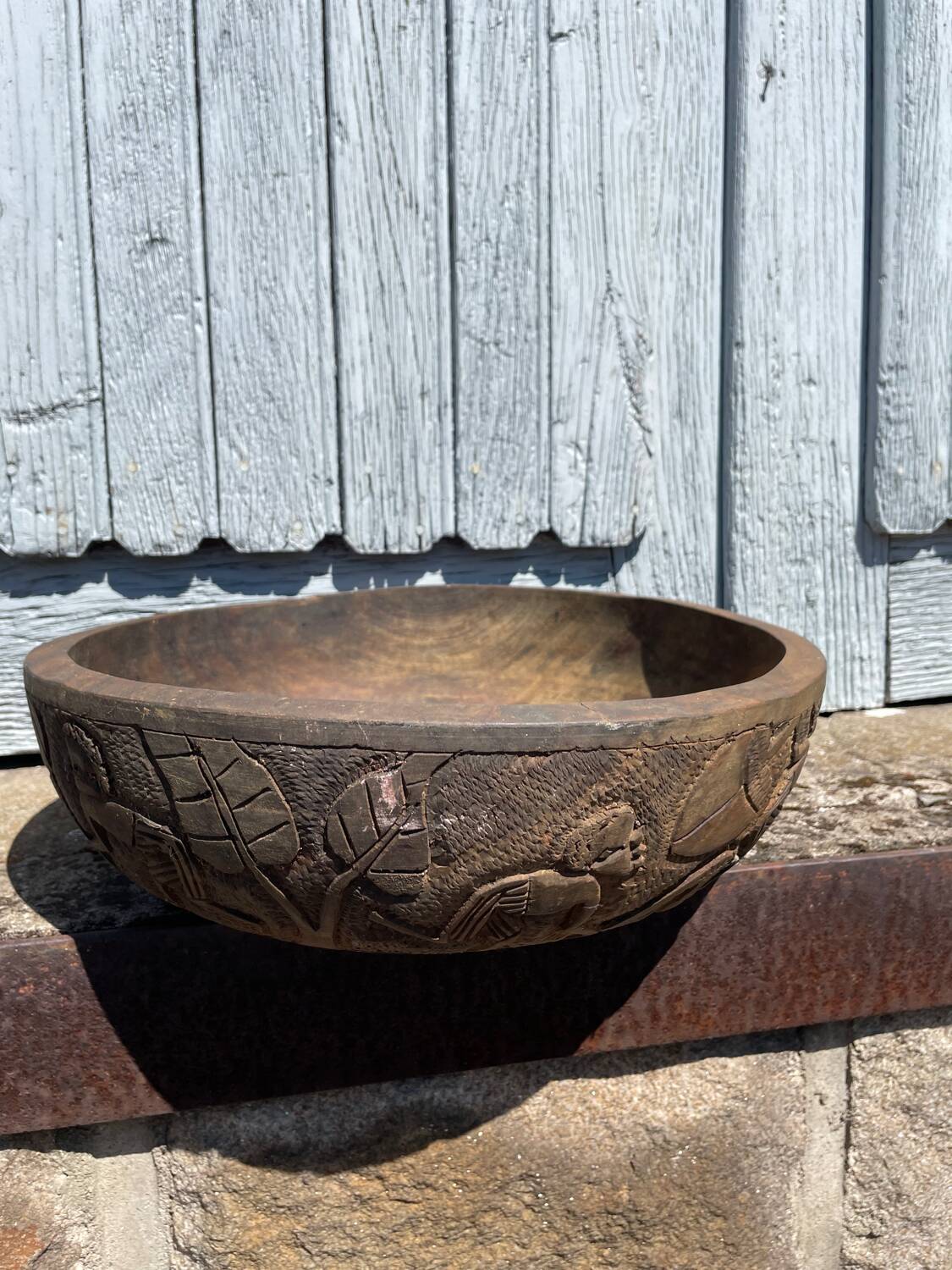 Old carved wooden bowl with African decoration.