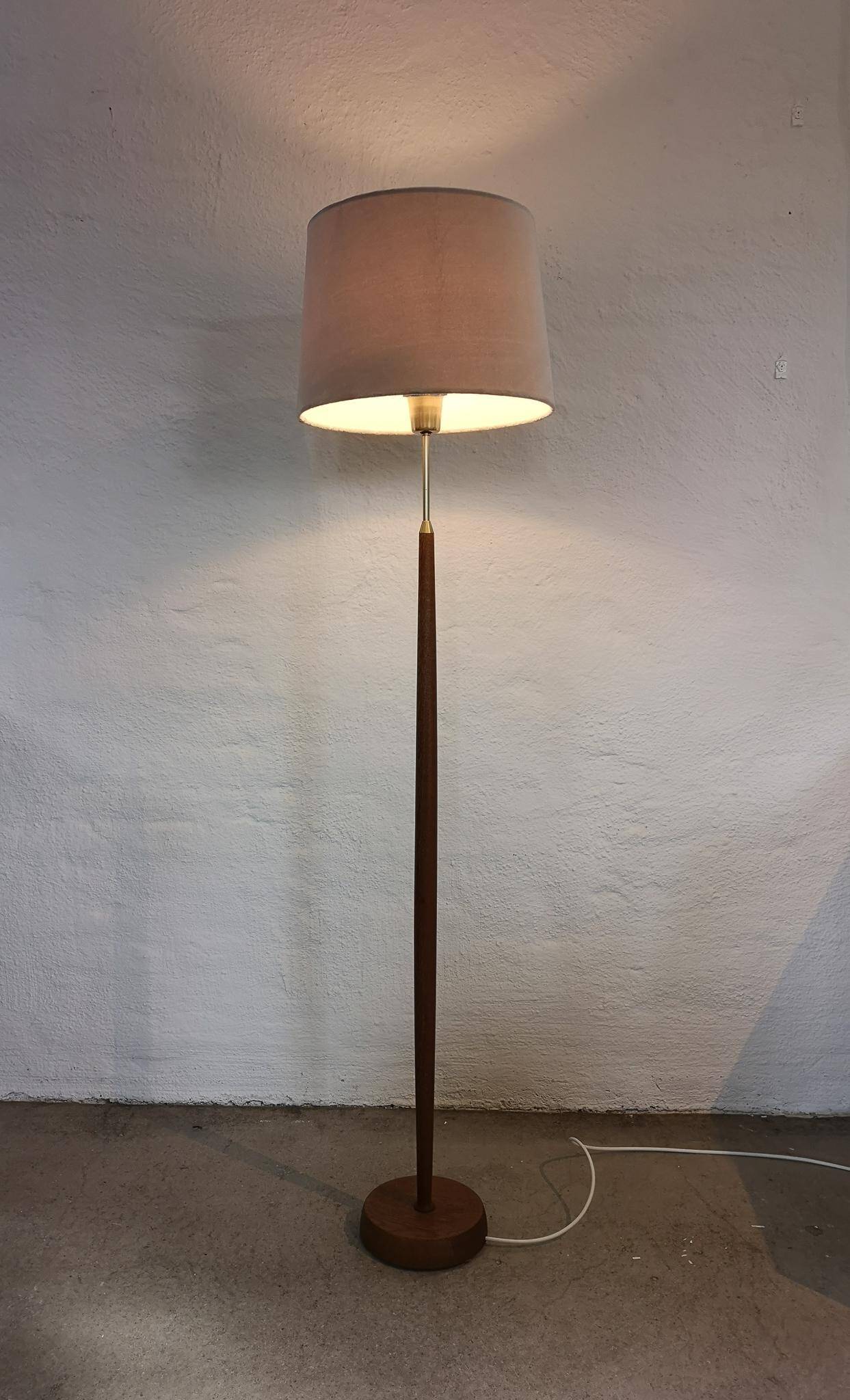 Mid-century floor lamp in teak and brass by Falkenbergs Belysning, Sweden, 1960s.
