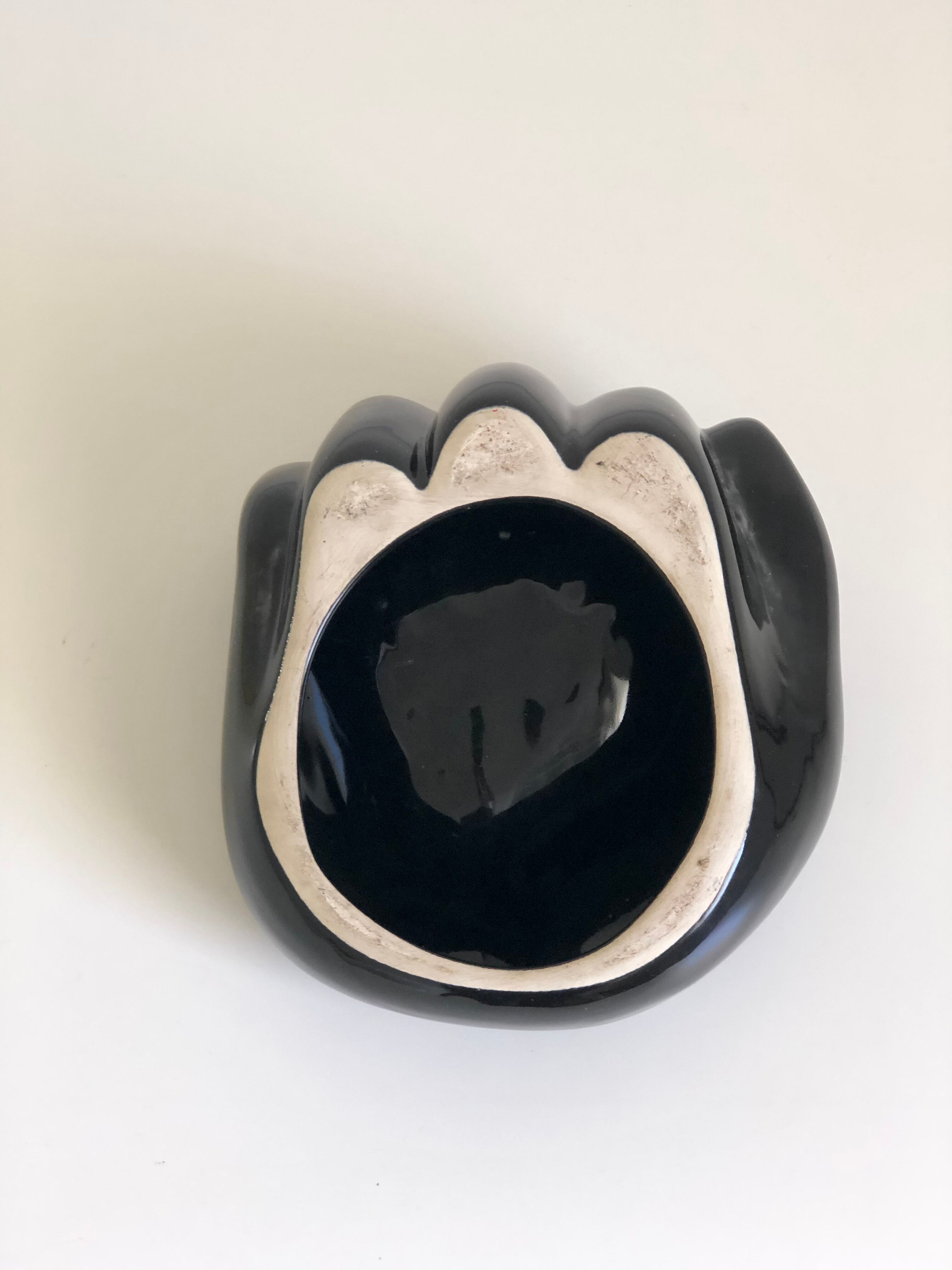 Empty black enamelled hand-shaped ceramic pocket, 1970