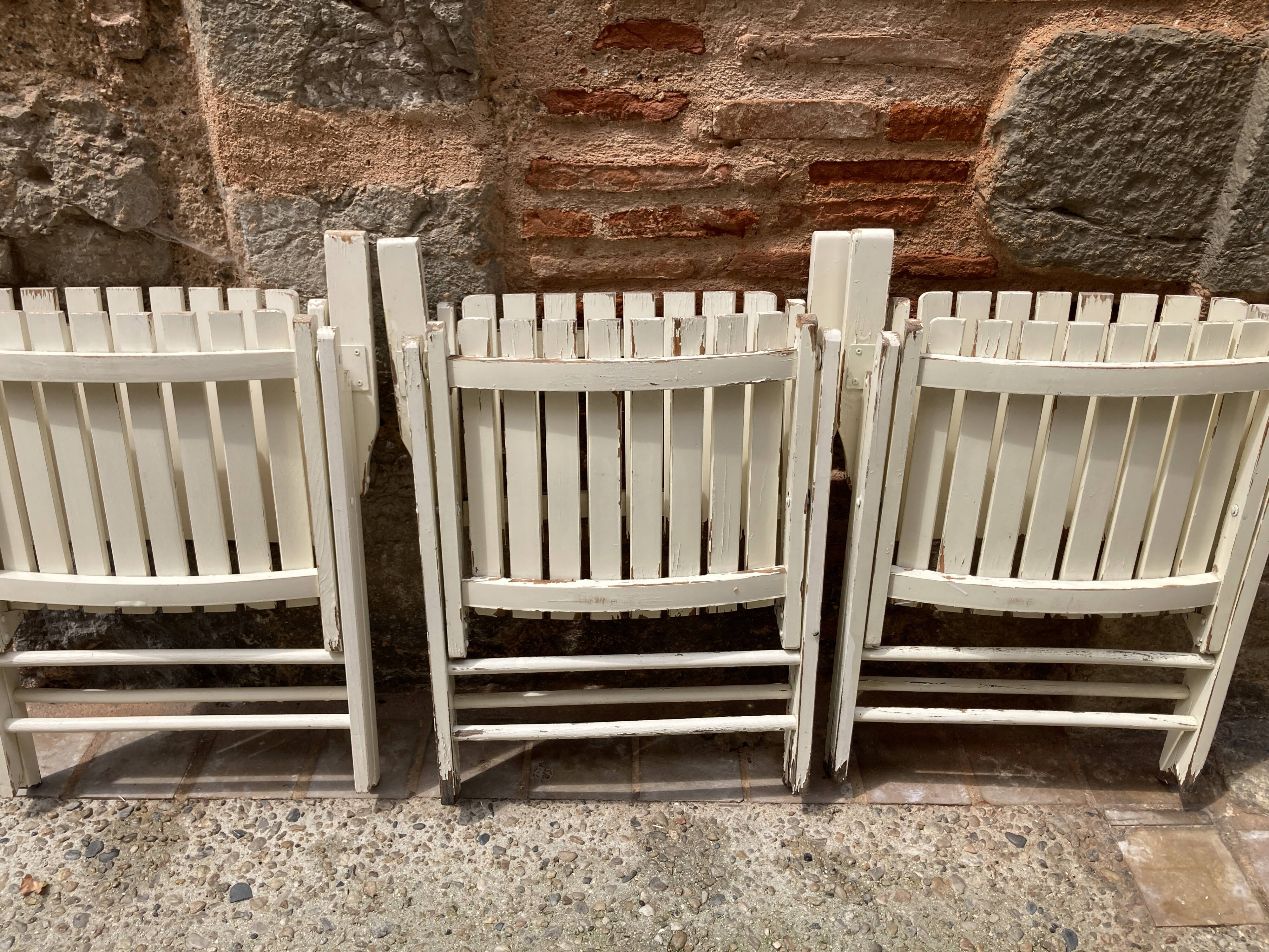 Five wooden garden armchairs