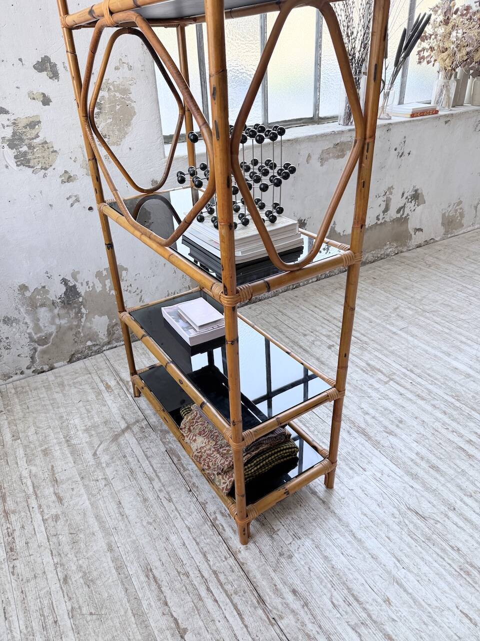 Rattan bookshelf and black glasses