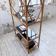 Rattan bookshelf and black glasses