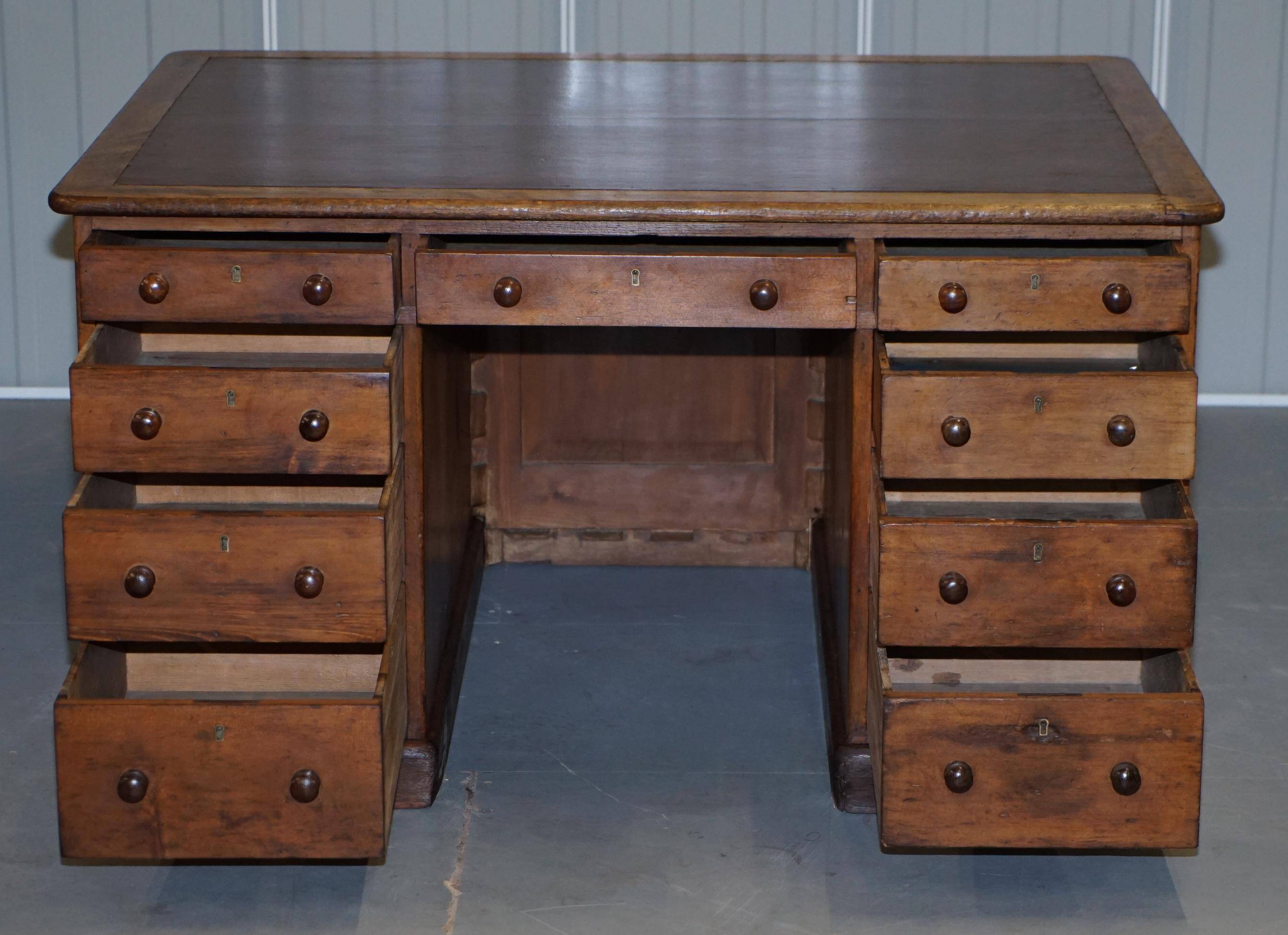 Antique Victorian oak kneehole desk with 18 double-sided drawers.