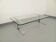 Table basse vintage en verre transparent et fonte d’aluminium des années 70