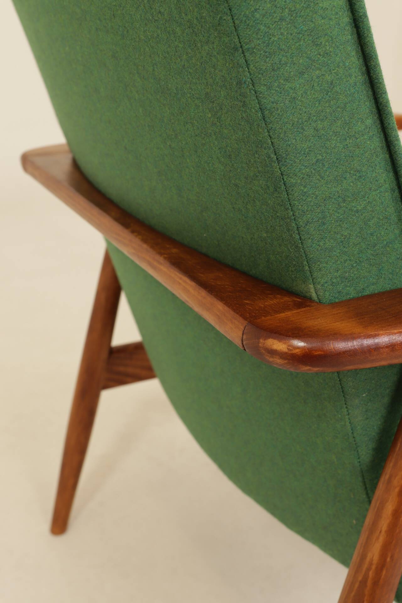 Scandinavian modern chair in green wool, vintage wooden armchair.