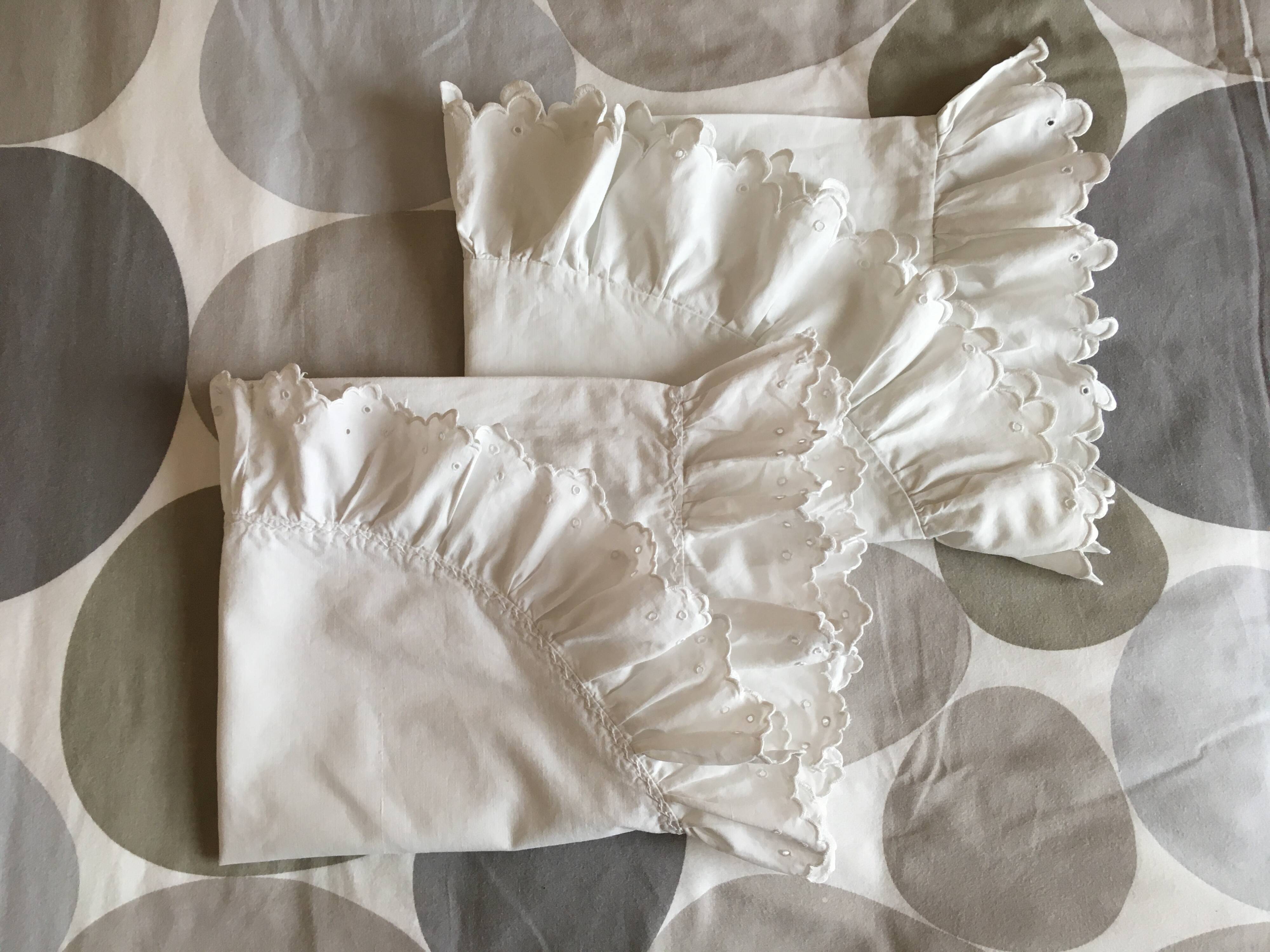 Two half-moon ruffled cushion covers