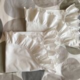 Two half-moon ruffled cushion covers