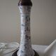 Table lamp for bedside use in earthenware with a wooden base.