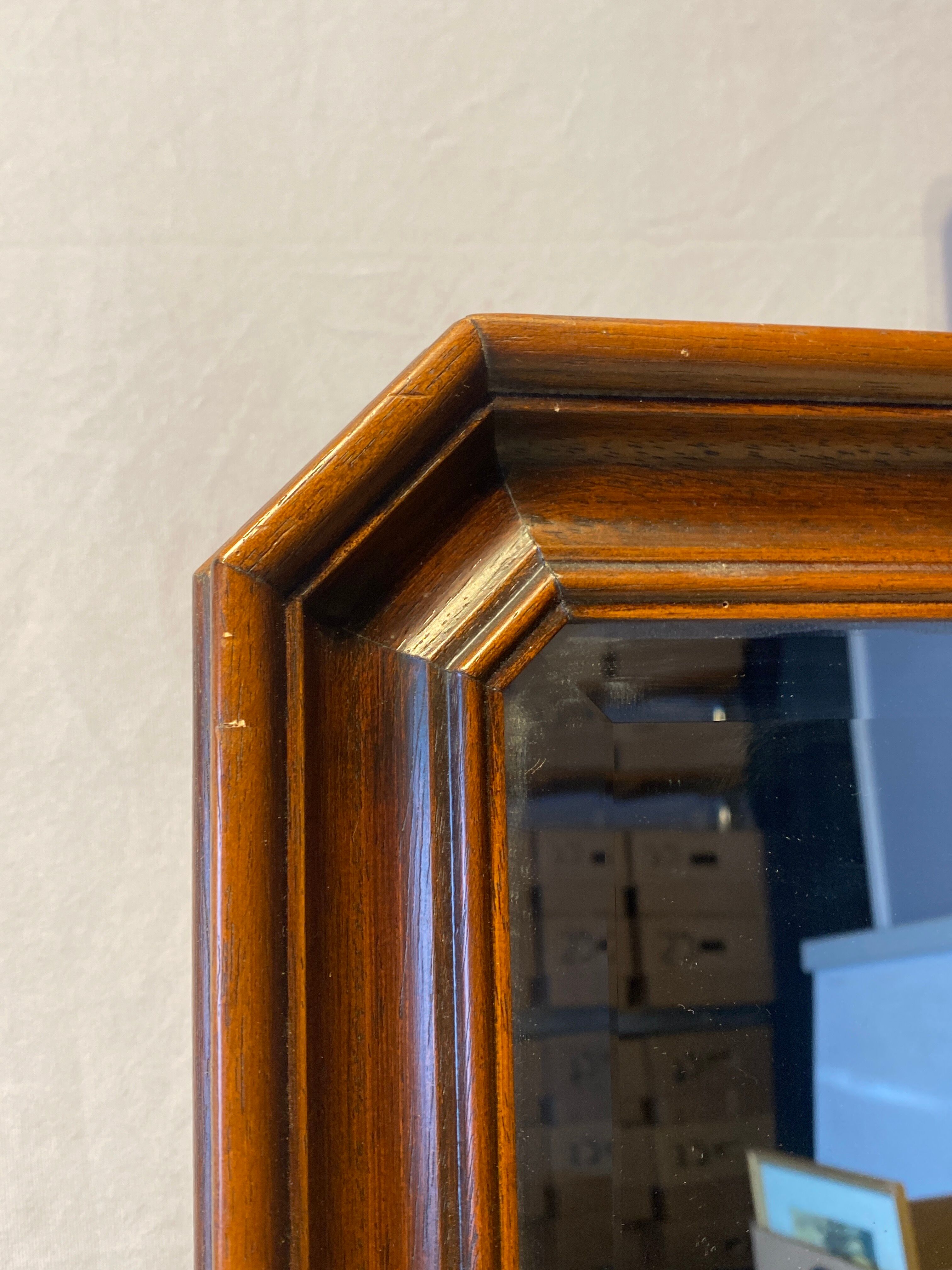 Beveled mirror in its wooden frame
