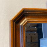Beveled mirror in its wooden frame