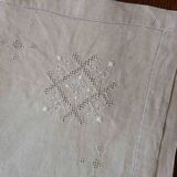 Embroidered string of white linen tablecloth