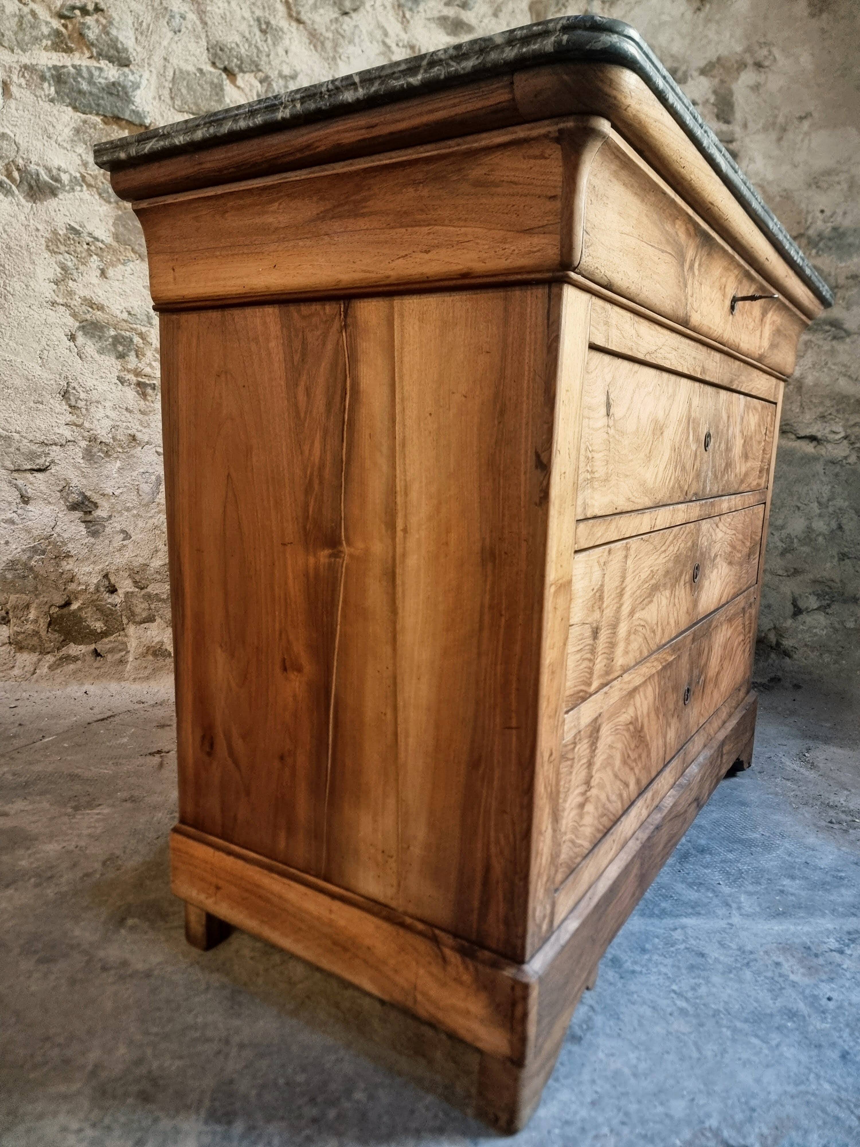 French antique walnut commode with a dark grey marble top, circa 1830–1860.