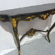 Console Napoléon III en bois noirci et fleurs dorées