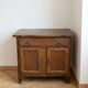 Rustic low cabinet in wood with herringbone marquetry.